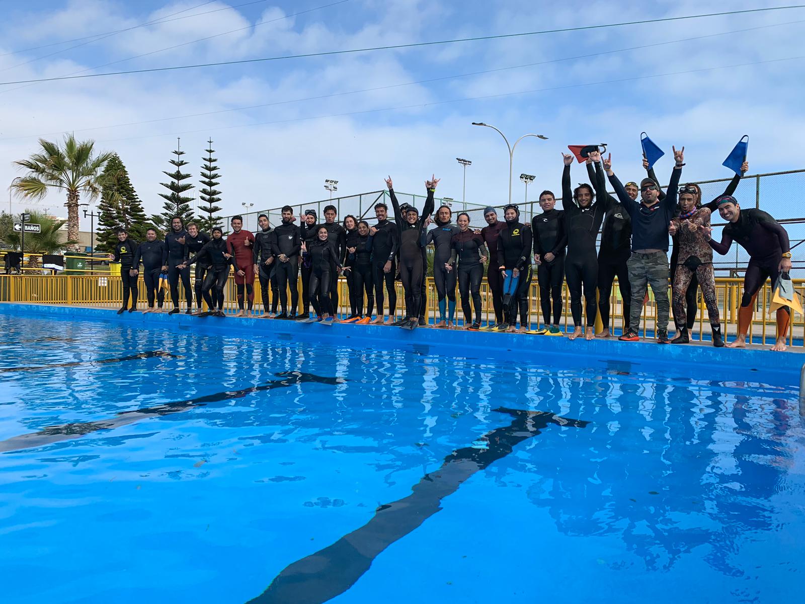 a group of people swimming in a pool of water