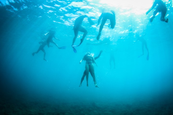a group of people swimming in the water
