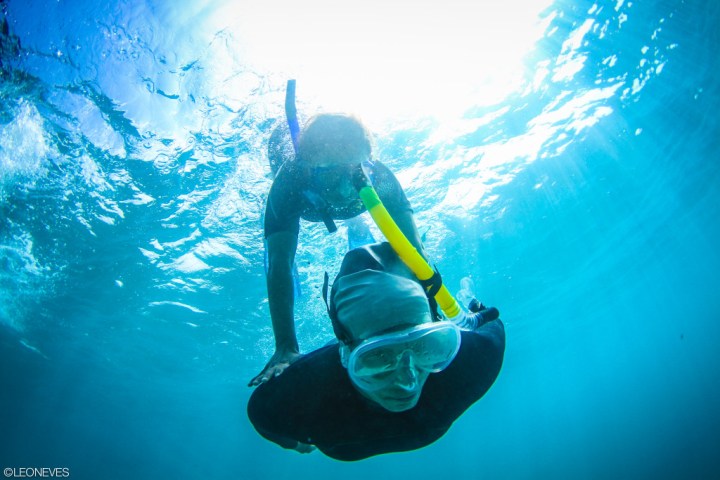 a man riding a wave on a surfboard in the water
