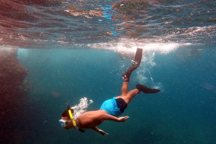 a man riding a wave on a surfboard in the water