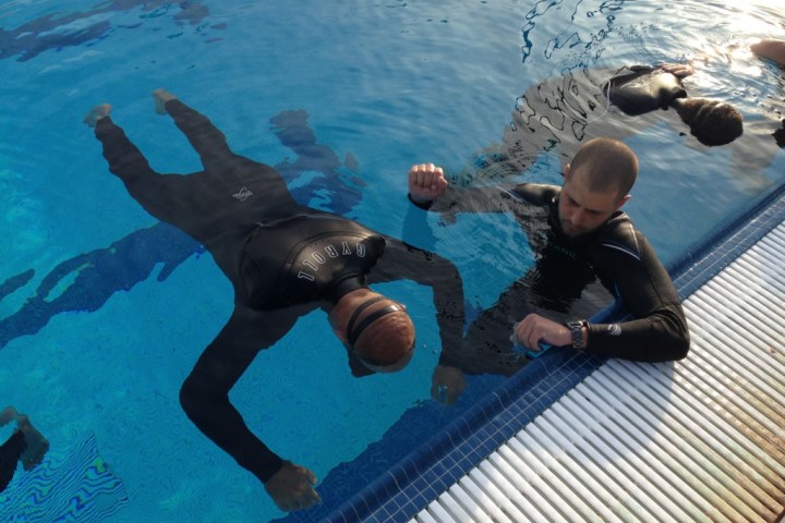 a child swimming in a pool of water
