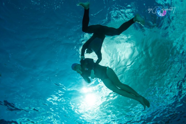 a man swimming in a pool of water