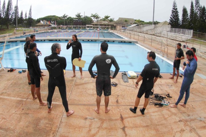 a group of people standing on a beach